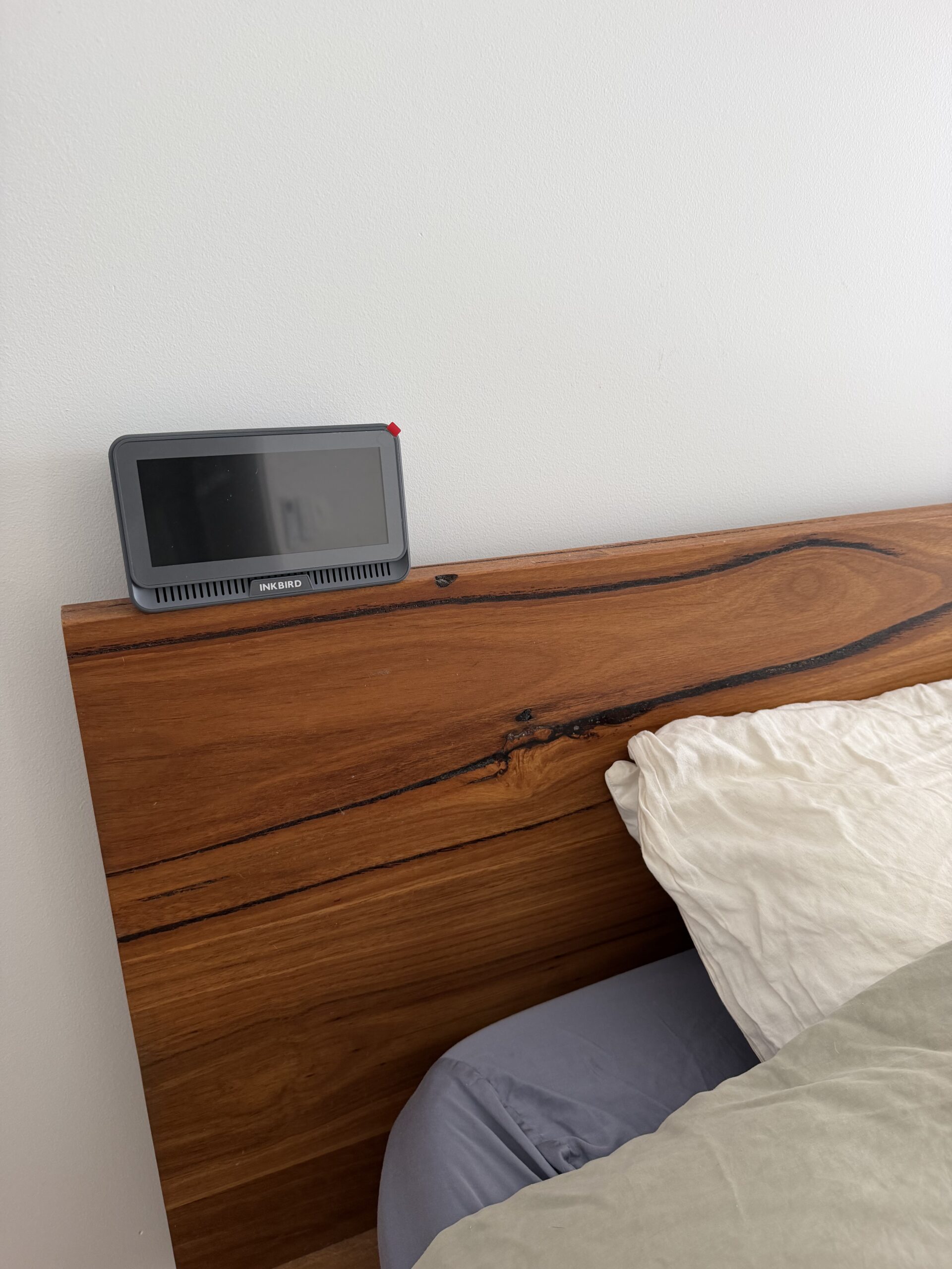 Inkbird air quality monitor on bedroom headboard — Palm Beach QLD testing