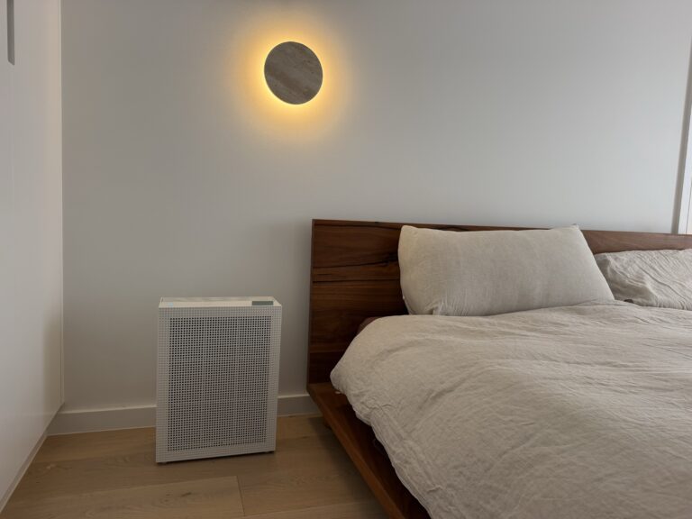 Coway Airmega 150 in a Palm Beach Queensland bedroom beside a timber bed with white linen
