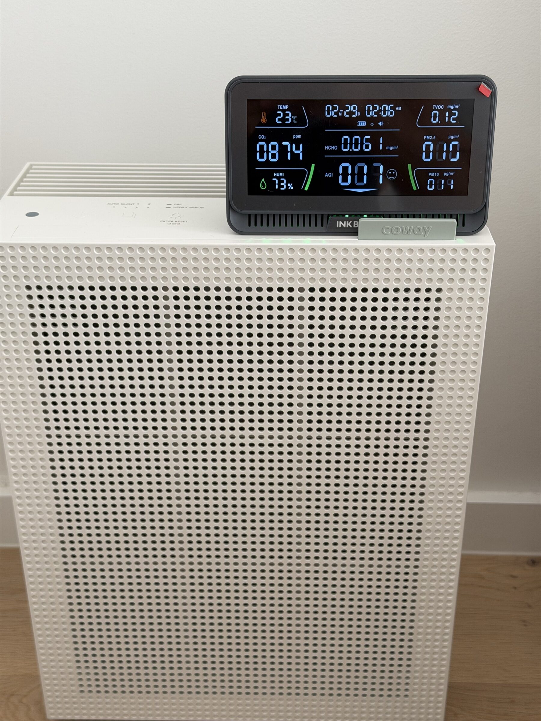 Inkbird IAQM-129-W air quality monitor on top of the Coway Airmega 150 showing live PM2.5, CO2, humidity, and temperature readings
