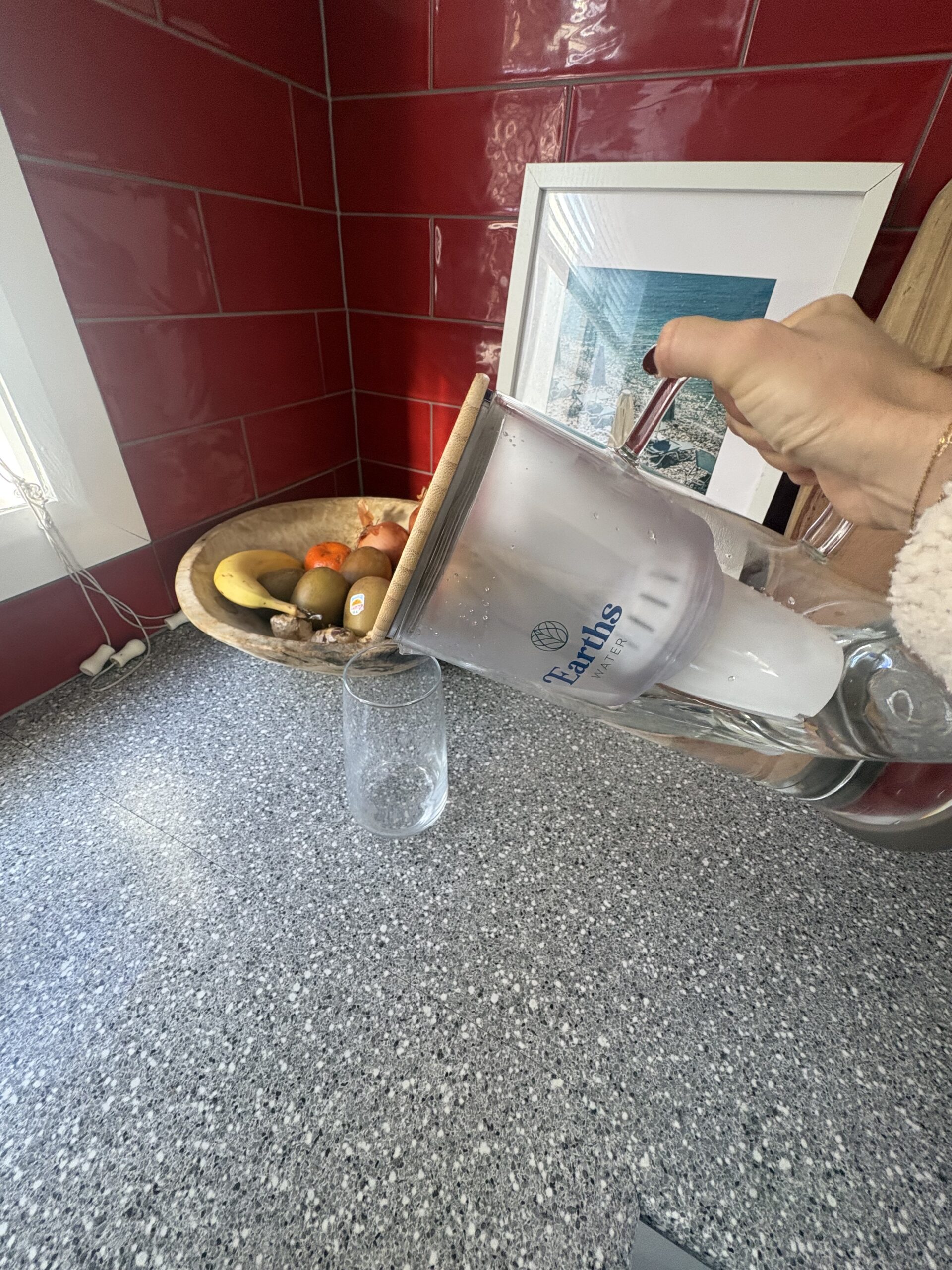 Earths Water 3.5L glass carafe being poured during testing