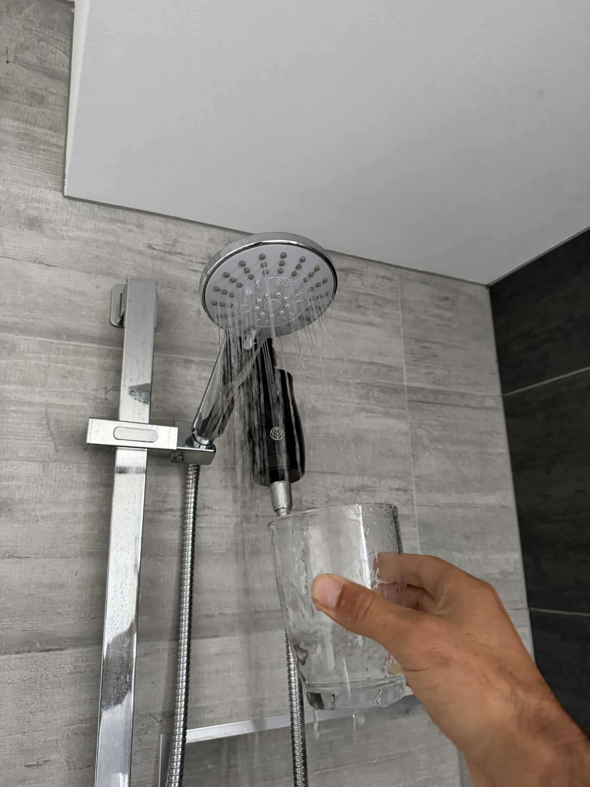 Collecting post-filter water sample from shower head — Palm Beach QLD