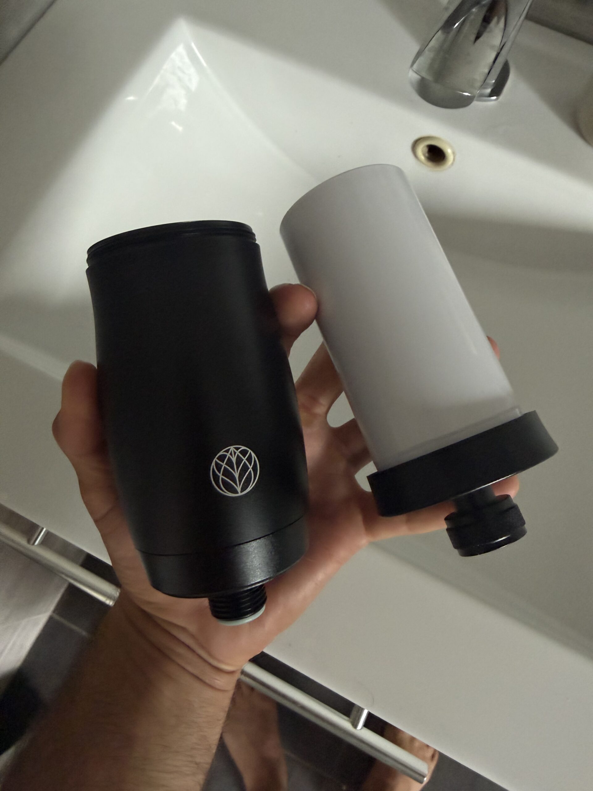 Earth's Water shower filter alongside the replacement cartridge — 5-stage media visible