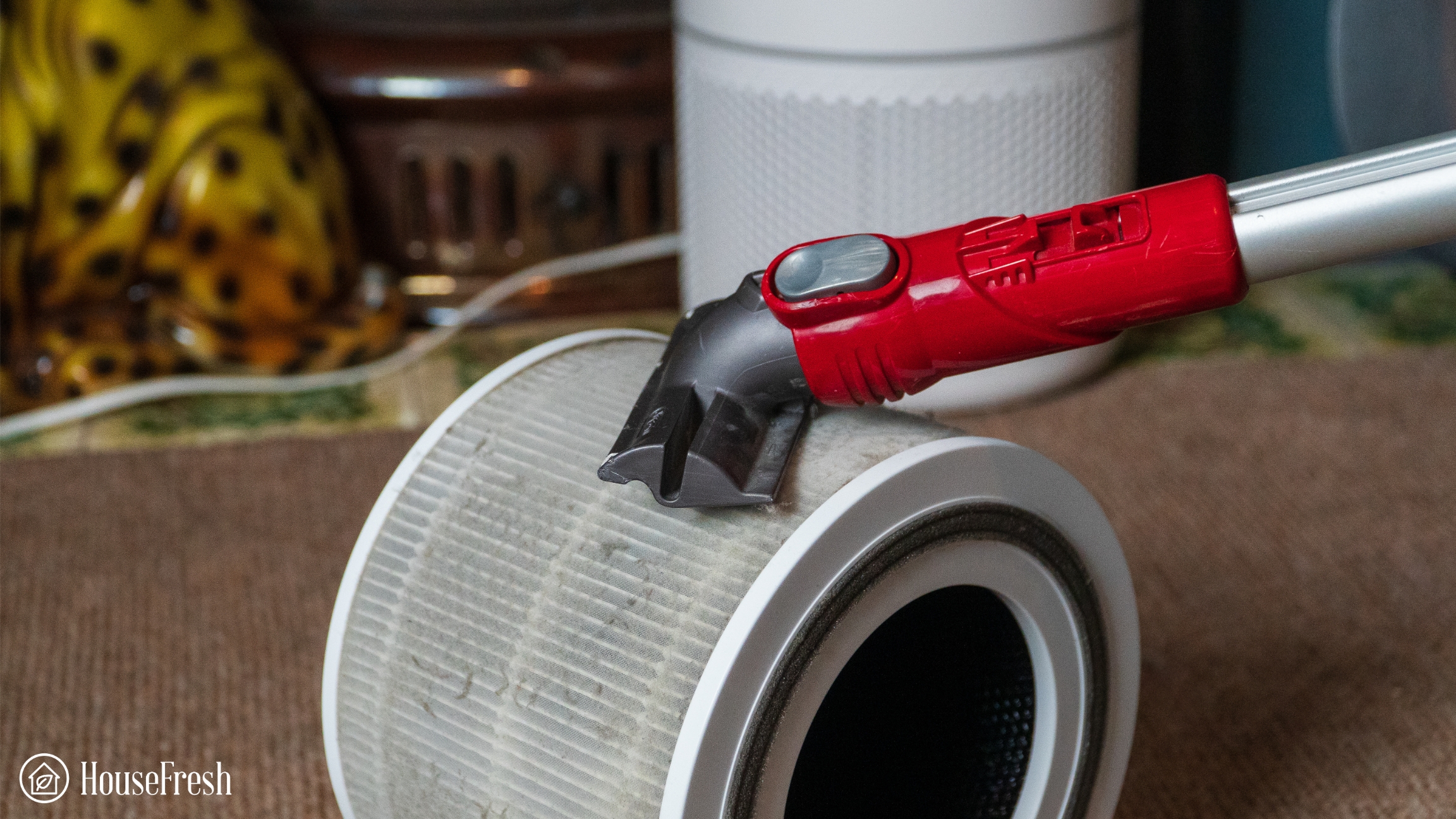 Vacuuming the Levoit Core 300S pre-filter surface to remove loose dust before replacement