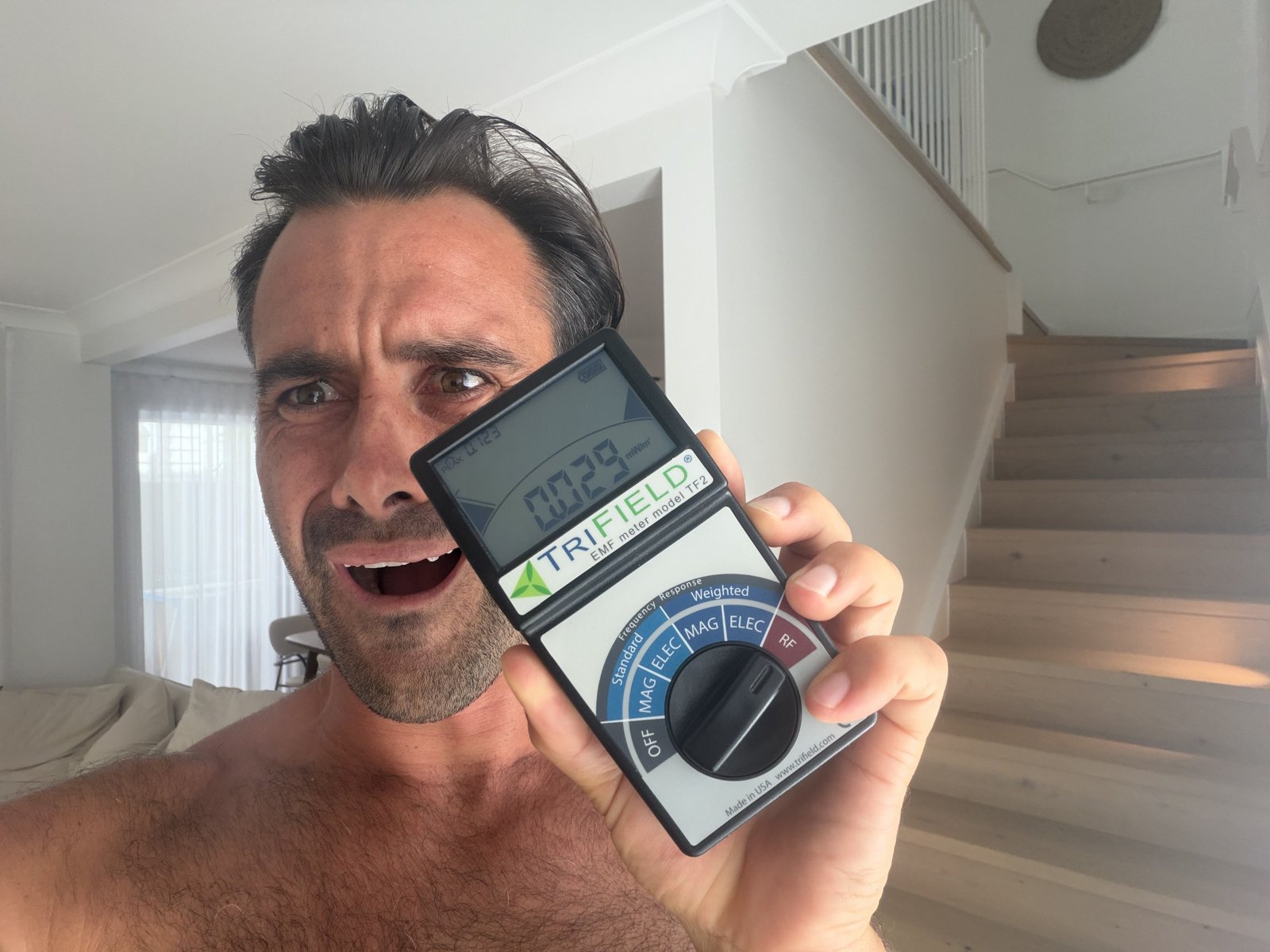 Jayce Love holding a TriField TF2 EMF meter close to camera showing a live reading